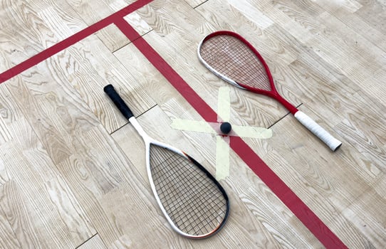 Sports, above and racket on squash court for competition, challenge and training center. Exercise, interior and empty room with top view of wooden floor of gymnasium for games, fitness club and gear photo
