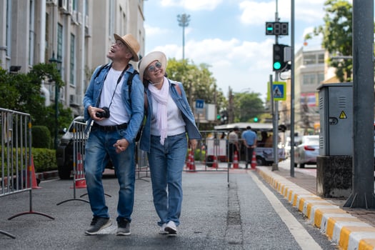 An elderly couple walks around the street in the old city of Bangkok, Thailand. photo