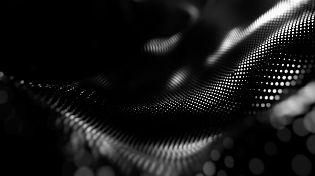 Smoothly flowing black fabric with shimmering dots creates a captivating abstract pattern and texture photo