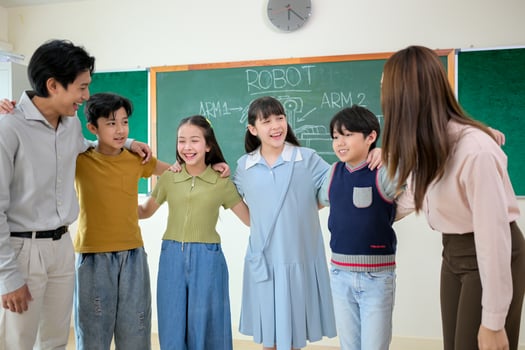 Portrait of a teacher and kids in a classroom where children have pleasure learning photo