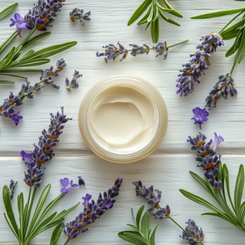 Lavender cream surrounded by fresh lavender and rosemary on a wooden surface photo