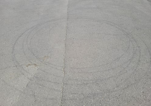 There are wheel circles on the gray summer sunny asphalt. photo
