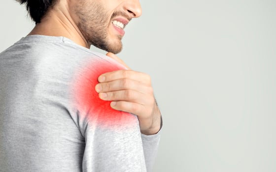 Inflammation in shoulder concept. Sore spot is highlighted in red photo