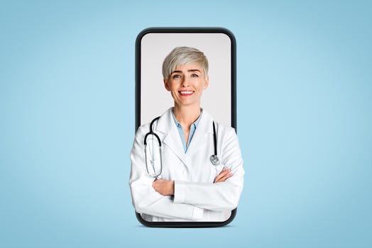 Friendly doctor waiting for patient concept. Smiling woman in white coat with crossed arms and stethoscope, isolated on light background photo