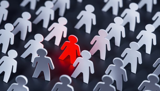 A glowing red figure standing surrounded by white figures, symbolizing leadership and creative idea, Different thinking, Individuality concept photo