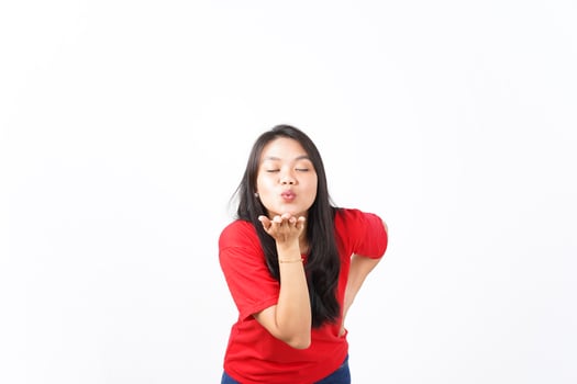 Blowing Kiss Of Beautiful Asian Woman wearing red shirt Isolated On White Background photo