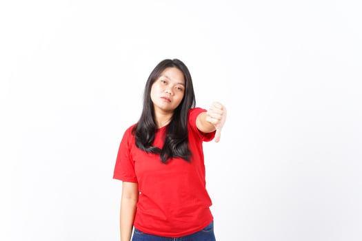 Showing Thumb Down, Dislike Concept Of Beautiful Asian Woman Wearing Red Shirt Isolated On White Background photo