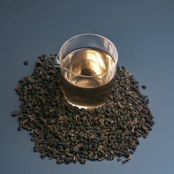 Experience the delightful and rich flavors of tea in a glass over dried leaves, a perfect aesthetic photo