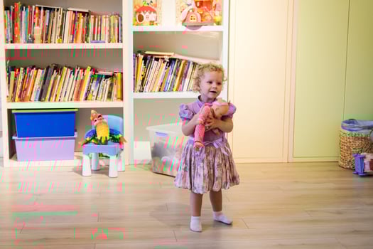 Beautiful blonde baby girl playing in kindergarten photo