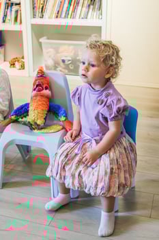 Beautiful blonde baby girl playing in kindergarten photo