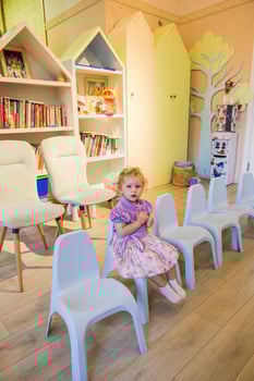 Beautiful blonde baby girl playing in kindergarten photo