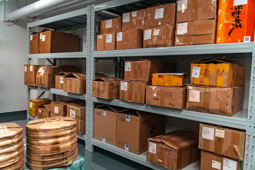 Organized storage in a warehouse is crucial, with packed boxes and labeled bins for efficiency photo