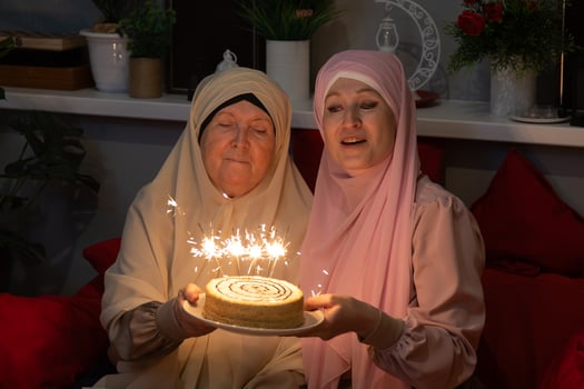 A woman holding a cake with sparklers on it photo