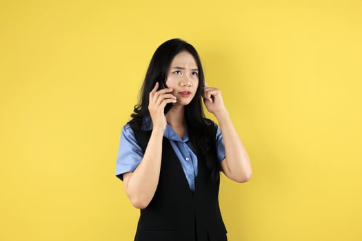 Thoughtfull Asian Female Online Shop Small Bussiness Owner Busy on Phone photo