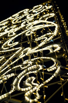 Christmas garland on the street in close-up. Yellow glow photo