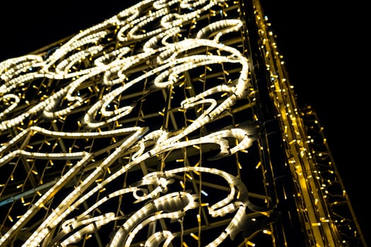 Christmas garland on the street in close-up. Yellow glow photo