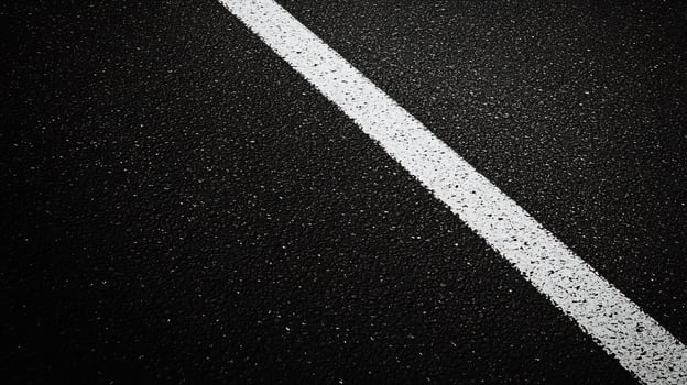Black and white photo of a road with white lines