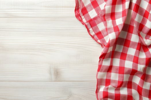 Red and white checkered cloth on wooden table photo