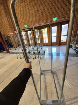A person is standing in front of a metal rack photo