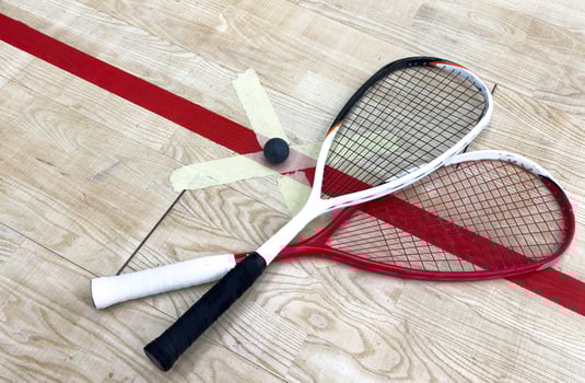 Empty squash court and rackets on the wooden floor. photo