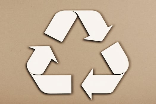 Recycle symbol on brown background photo