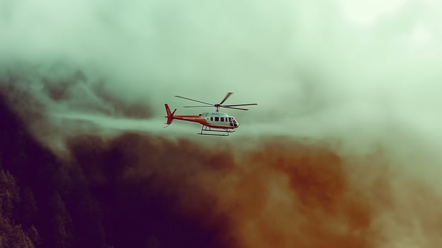 A helicopter flying through the clouds photo
