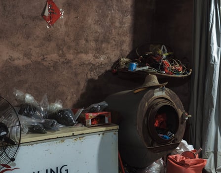 A cluttered workshop filled with various tools, equipment, and materials in disarray photo