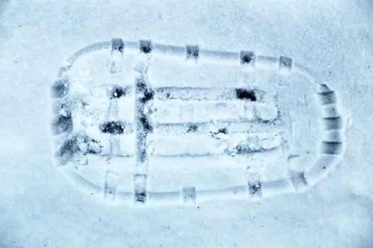 Impression of traditional snow shoe on the ground photo