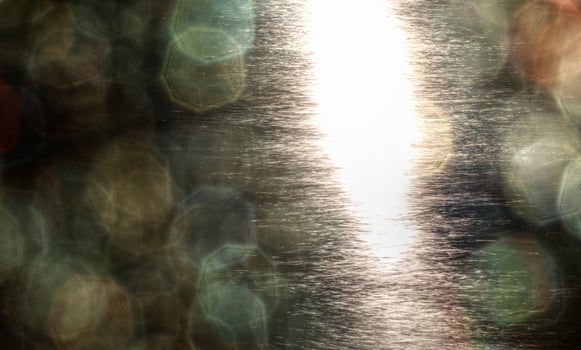 Abstract shot of sunlight reflections on the water and lens flare bokeh photo