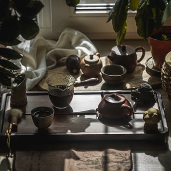 An Elegant Tea Setup Featuring a Beautiful Ceramic Teapot Bathed in Soft Natural Light photo