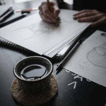 A Creative Workspace That Features Drawing, Imaginative Endeavors, and Enjoying Tea photo
