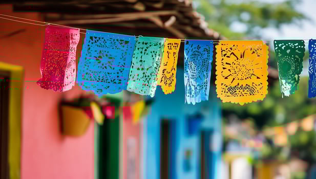 Colorful paper flags hanging from a line on a street photo