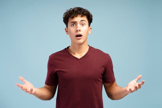 Portrait of sad, upset teen boy with open mouth looking at camera. Unhappy concept photo
