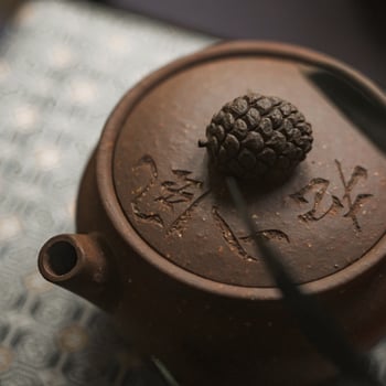 An Elegant Teapot with a Beautifully Intricate Design Features a Natural Lid and Flair photo