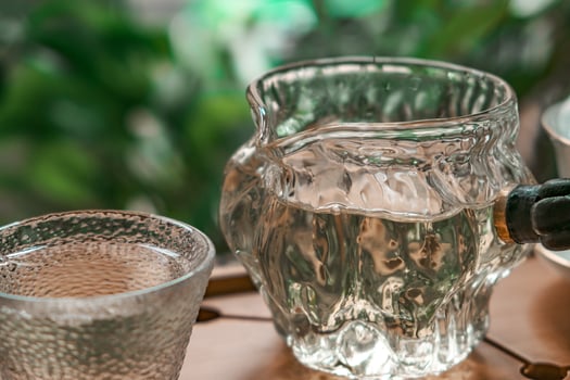 A Beautiful and Refreshing Glass Pitcher of Water Surrounded by the Magnificence of Nature Outdoors photo