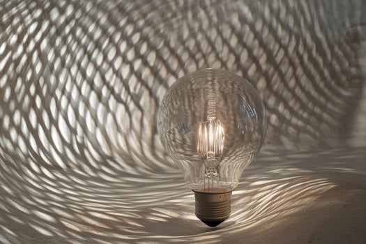 A Light Bulb Casts Shadows on a Textured Surface photo