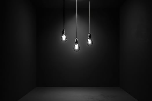 Three Light Bulbs Hanging in a Dark Room photo