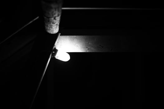 Monochrome shot of vintage lamp at a wooden beam photo