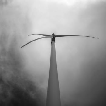 Monochrome shot of wind turbine and clouds photo