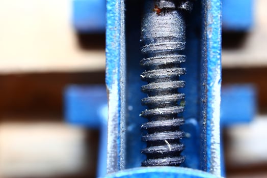Close up of threaded axle in blue metal frame photo