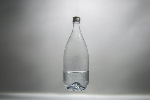 A Partially Filled Plastic Water Bottle Hanging Upside Down photo