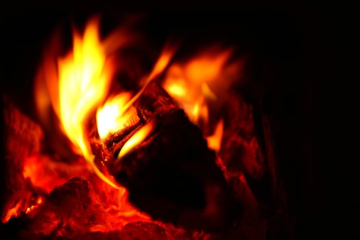 Macro of burning firewood in a stove photo