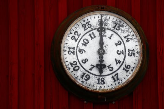 Old clock on a red wooden wall photo