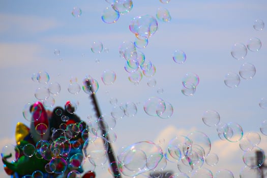 Many colorful bubbles and balloons on a fair photo
