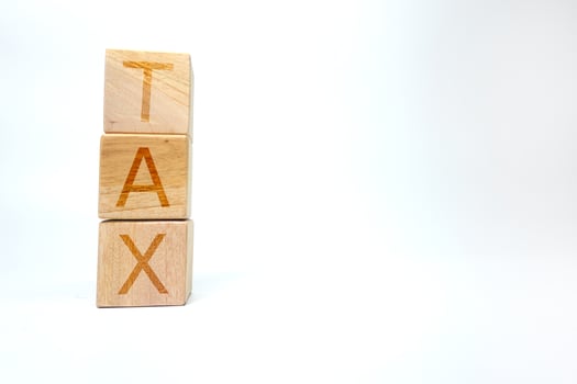 Wooden Blocks Spelling TAX with Minimalistic White Background photo