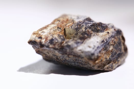 Macro of pyrite crystal fools gold in a rock, isolated on white photo