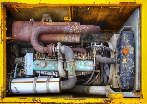 Engine bay of an old and rusty excavator photo