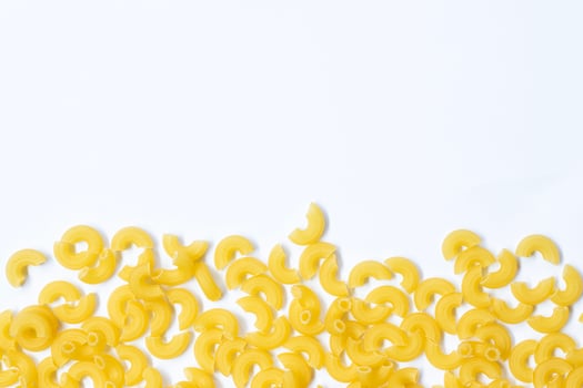 raw macaroni pasta isolated on white background with full depth of field. Top view. Lay flat photo