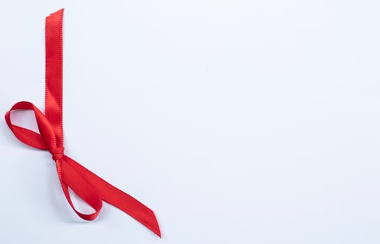 Red ribbon bow on white background. studio shooting photo