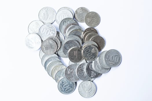 A stack of coins in isolation on a white background top view photo